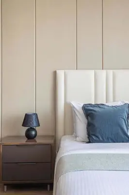 a bedroom with a bed and a lamp on a night stand at Frank Porter - Nobles Tower in Dubai