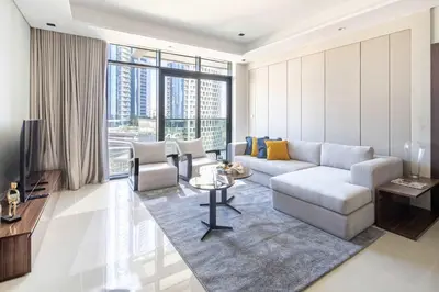 a living room with a couch and a table at Frank Porter - Nobles Tower in Dubai