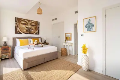 a bedroom with a large bed with a face on the wall at Frank Porter - Bahar 6 in Dubai