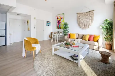 a living room with a couch and a table at Frank Porter - Bahar 6 in Dubai