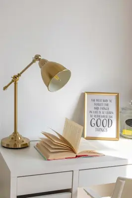 an open book on a desk with a lamp and a sign at Frank Porter - Bahar 6 in Dubai