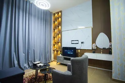 a living room with a tv and a chair at High Class 1bhk Business bay Marasi Drive Dubai in Dubai