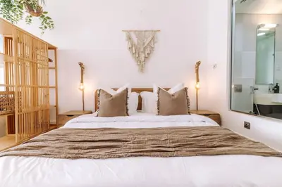 a bedroom with a large bed with a large mirror at Beachfront Bliss on the Palm Jumeirah in Dubai