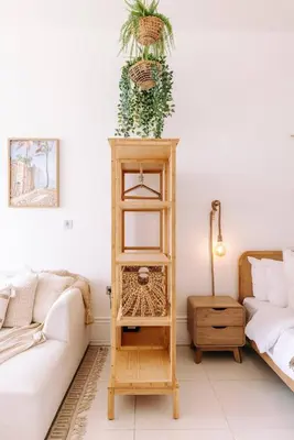 a living room with a wooden cabinet with a plant on it at Beachfront Bliss on the Palm Jumeirah in Dubai