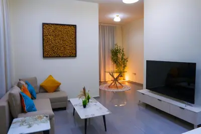 a living room with a large flat screen tv at Lala Land Homes - Magnificent 1 Br in Business Bay in Dubai