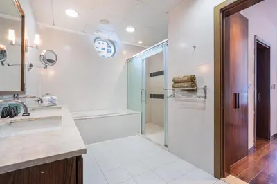 a bathroom with a shower and a sink at Palm Home next to Nakheel Mall with Private Beach in Dubai
