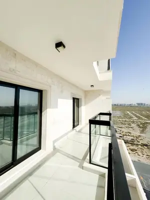 a staircase in a white building with windows at Cozy 1 Bedroom Apartment in Dubai