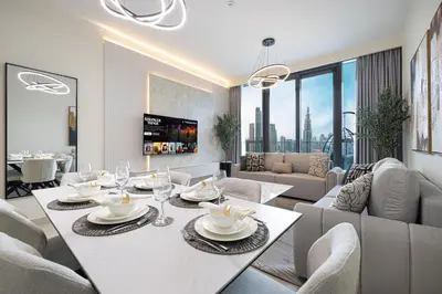a dining room with a white table and chairs at High-Floor Luxe 2BR Stunning Burj Khalifa & Fountain Views Direct Dubai Mall Access in Dubai