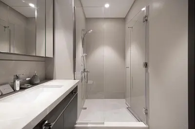 a white bathroom with a shower and a sink at High-Floor Luxe 2BR Stunning Burj Khalifa & Fountain Views Direct Dubai Mall Access in Dubai