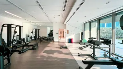 a gym with treadmills and machines in a room at High-Floor Luxe 2BR Stunning Burj Khalifa & Fountain Views Direct Dubai Mall Access in Dubai