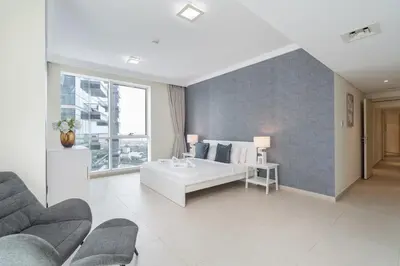 a living room with a bed and a couch at Premium 3-bedroom with Direct Beach Access in JBR in Dubai