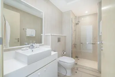 a bathroom with a sink and a toilet and a shower at Premium 3-bedroom with Direct Beach Access in JBR in Dubai