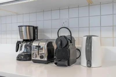 a kitchen counter with a toaster and a coffee maker at Premium 3-bedroom with Direct Beach Access in JBR in Dubai