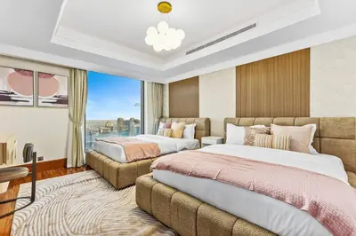 a hotel room with two beds and a window at Luxury 6BR JBR Penthouse Panoramic Sea Views, Steps to Marina Beach & The Walk in Dubai