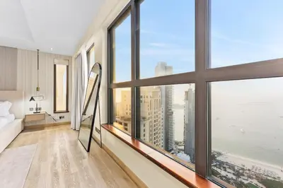 a room with large windows with a view of the ocean at Luxury 6BR JBR Penthouse Panoramic Sea Views, Steps to Marina Beach & The Walk in Dubai