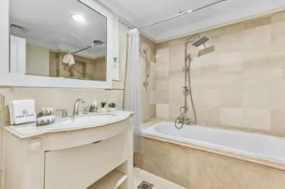 a bathroom with a sink and a tub and a mirror at Luxury 6BR JBR Penthouse Panoramic Sea Views, Steps to Marina Beach & The Walk in Dubai