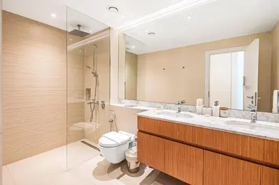 a bathroom with a toilet and a sink and a shower at Escape24 Luxury 2BR Sea View with Beach Access in La Mer in Dubai