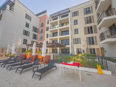a row of chairs and tables in front of a building at Escape24 Luxury 2BR Sea View with Beach Access in La Mer in Dubai