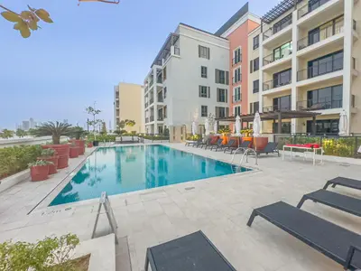 a swimming pool in the middle of a building at Escape24 Luxury 2BR Sea View with Beach Access in La Mer in Dubai