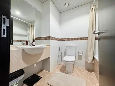 a bathroom with a white toilet and a sink at 2 Bed Apartment in La Riviera Tower, Dubai Marina near Metro and Mall, 12-min walk to JBR Beach! in Dubai