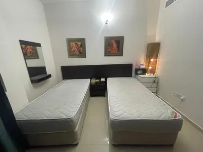 a room with two beds in a room at Room In Barsha Heights in Dubai