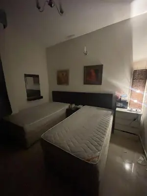 a living room with a bed and a couch at Room In Barsha Heights in Dubai