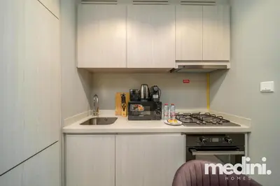 a small kitchen with a sink and a stove at New Listing - Sauna - Gym Pool - Business Bay in Dubai