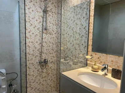 a bathroom with a sink and a shower at Jumeirah Village Circle JVC One bedroom Luxurious Apartment in Dubai