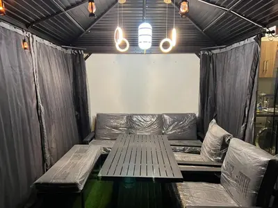 a couch in a tent with a table and lights at Jumeirah Village Circle JVC One bedroom Luxurious Apartment in Dubai