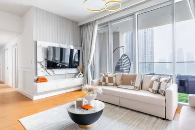 a living room with a couch and a tv at Luxurious 4BR, Burj Khalifa & full fountain view, Downtown Dubai in Dubai
