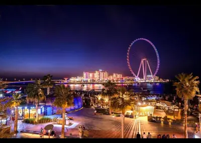 a city with a ferris wheel at night at AHLAN Dubai Marina JBR in Dubai
