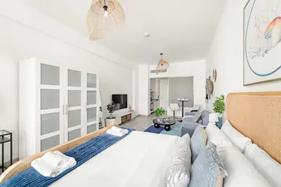 a living room with a large bed and a couch at Silkhaus Sea View Studio in Palm Jumeirah in Dubai