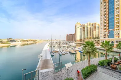 a marina with boats in the water next to buildings at Silkhaus Offshore Studio in Palm Views East Tower in Dubai
