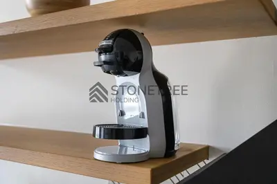 a black and silver coffee maker on a shelf at Bright 1BR at Collective Tower 1 Near Hills Mall in Dubai