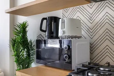 a coffee maker sitting on top of a microwave at Bright 1BR at Collective Tower 1 Near Hills Mall in Dubai