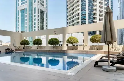 a swimming pool with an umbrella and some buildings at Dubai Marina, 2 Bedrooms, apartment, sea view, JBR in Dubai