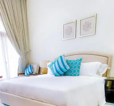 a bedroom with a white bed with blue and white pillows at Dubai Marina, 2 Bedrooms, apartment, sea view, JBR in Dubai