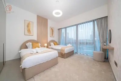 a hotel room with two beds and a large window at Cozy 2-Bed Home with Burj Khalifa Views 204GR-2 in Dubai