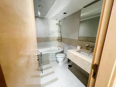 a bathroom with a toilet and a sink at Blakely 2BR Lakeview Retreat - Open Balcony and Marina Views in Dubai