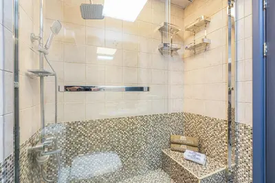 a bathroom with a shower with a glass door at Elegant Home in the Heart of Marina in Dubai