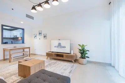 a living room with a tv and a couch at Elegant Home in the Heart of Marina in Dubai