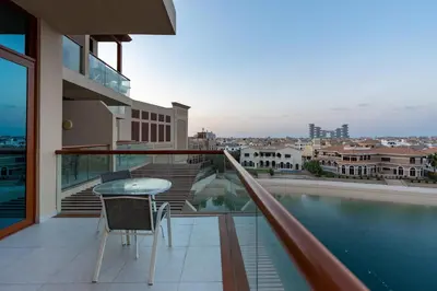 a balcony with a table and a view of the city at Deluxe Waterfront Unit in Heart Of Dubai Palm Jumeirah in Dubai