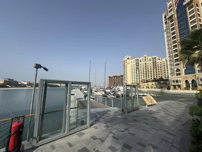 a view of a marina with some glass doors at Deluxe Waterfront Unit in Heart Of Dubai Palm Jumeirah in Dubai