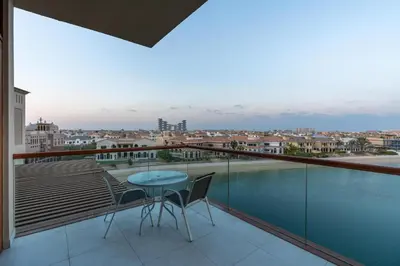 a balcony with a table and chairs and a view at Deluxe Waterfront Unit in Heart Of Dubai Palm Jumeirah in Dubai