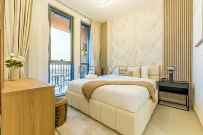 a bedroom with a large bed and a balcony at Charming 1BR in Dania 3, IMPZ by Deluxe Holiday Homes in Dubai