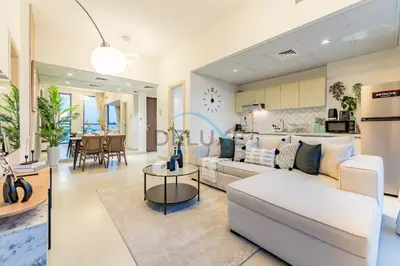 a living room with a couch and a table at Charming 1BR in Dania 3, IMPZ by Deluxe Holiday Homes in Dubai