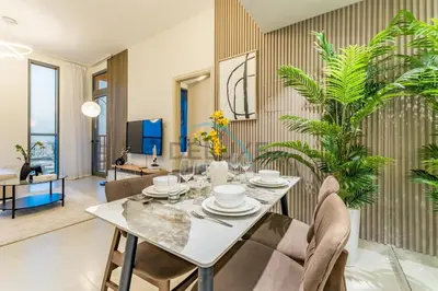 a dining room with a table and chairs at Charming 1BR in Dania 3, IMPZ by Deluxe Holiday Homes in Dubai