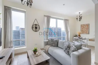 a living room with a couch and a table at Tranquil 1BR in Burj Views Tower B, Downtown by Deluxe Holiday Homes in Dubai