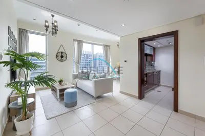 a living room with a couch and a table at Tranquil 1BR in Burj Views Tower B, Downtown by Deluxe Holiday Homes in Dubai