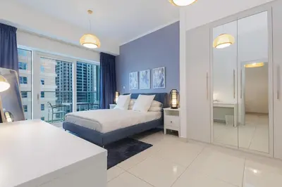 a bedroom with a king sized bed and a bathroom at Sea View, Easy Access, Close to All Amenities in Dubai